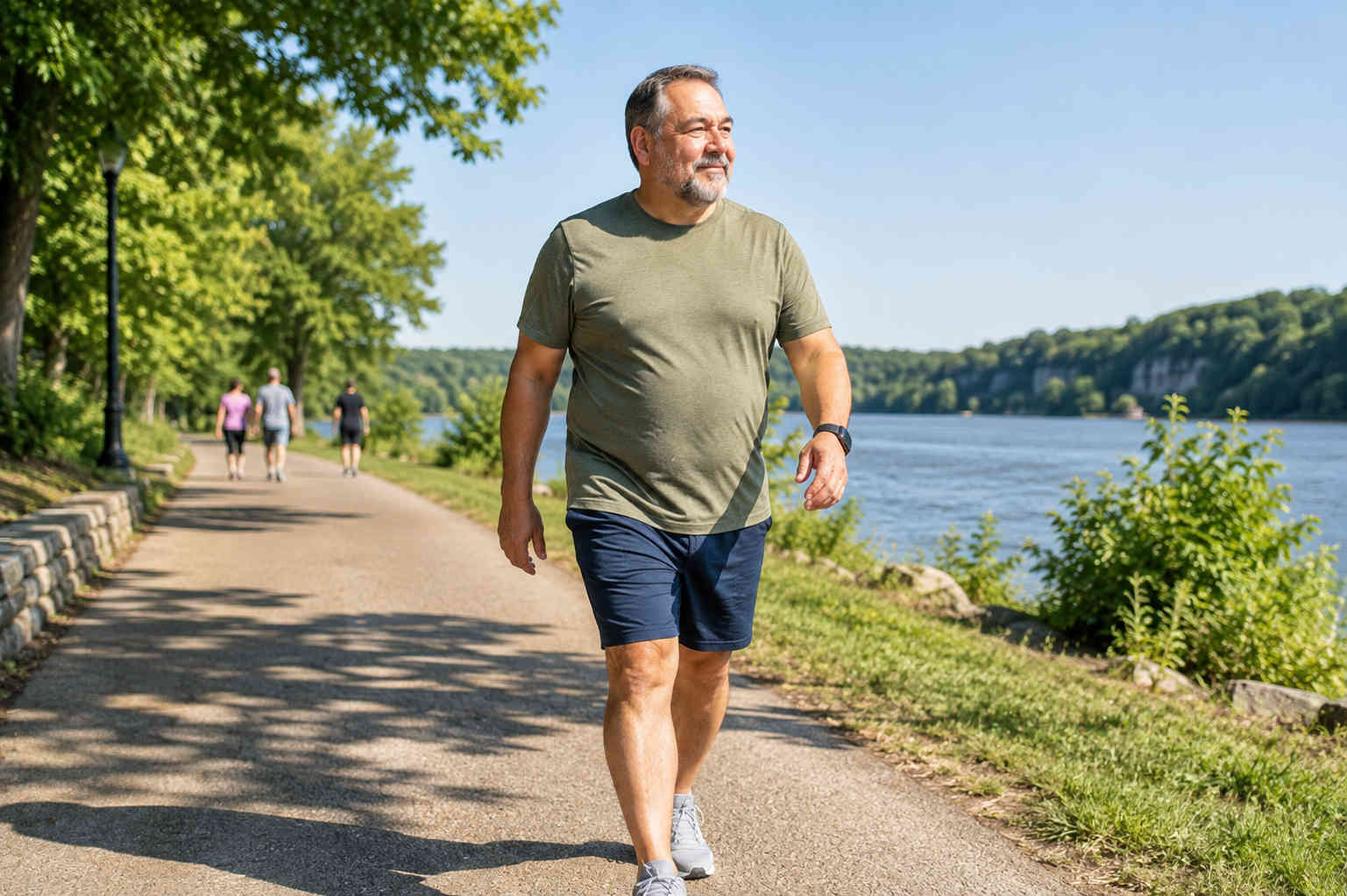 Older man walking confidently beside the water after building a consistent beginner fitness habit