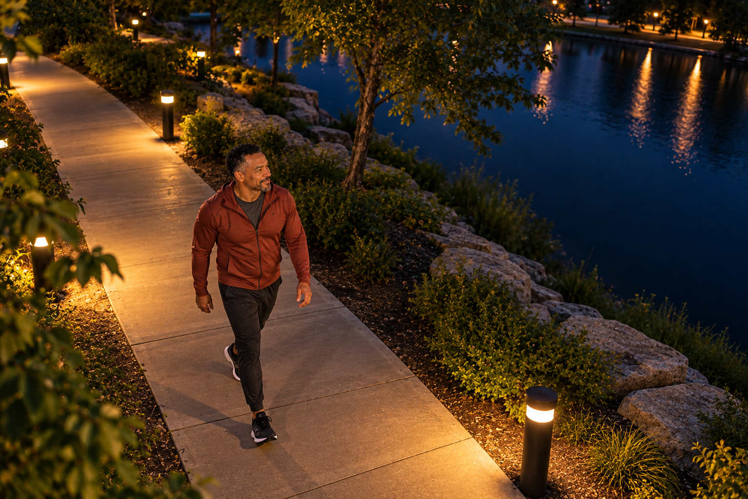 High-angle view of Marcus taking a relaxed evening walk beside the water before bedtime